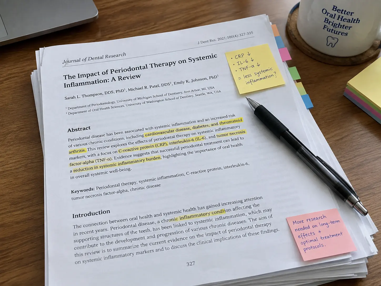 A stack of printed dental journal articles annotated for a literature review