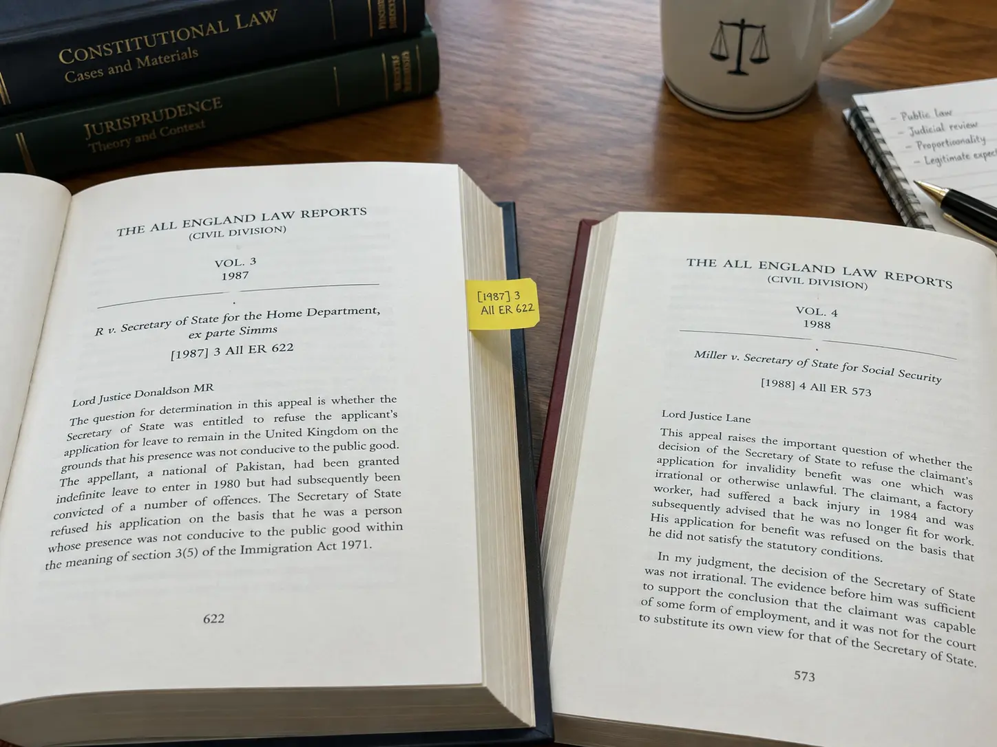 Two Nigerian law report volumes open on a desk for case citation research