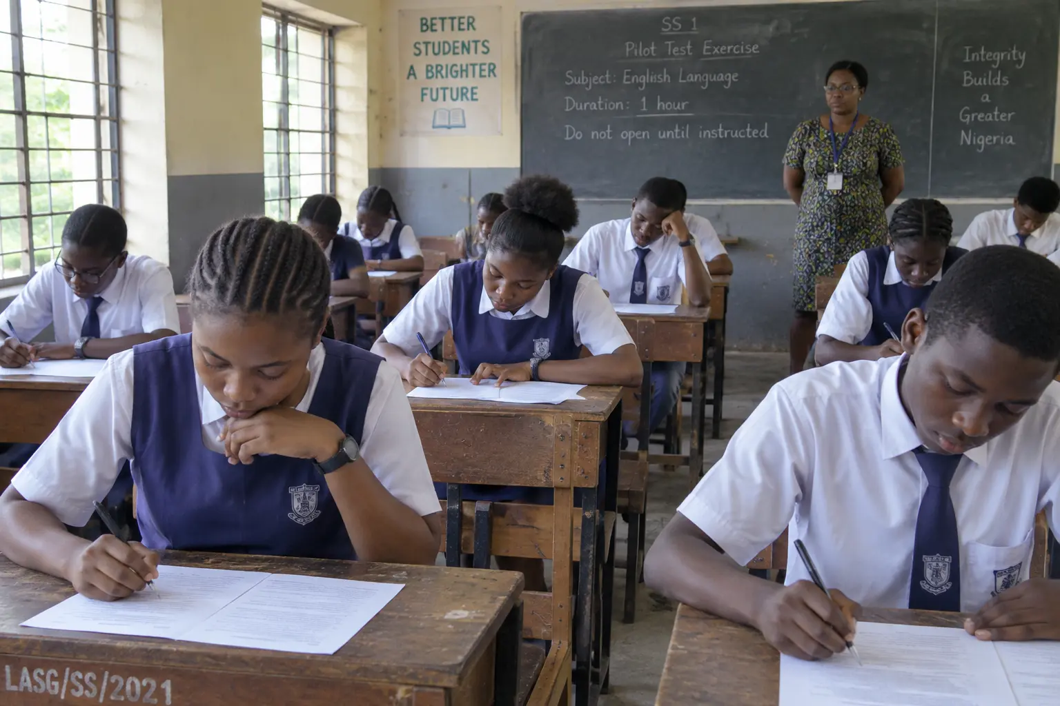 Students completing a printed test during a pilot of a research instrument